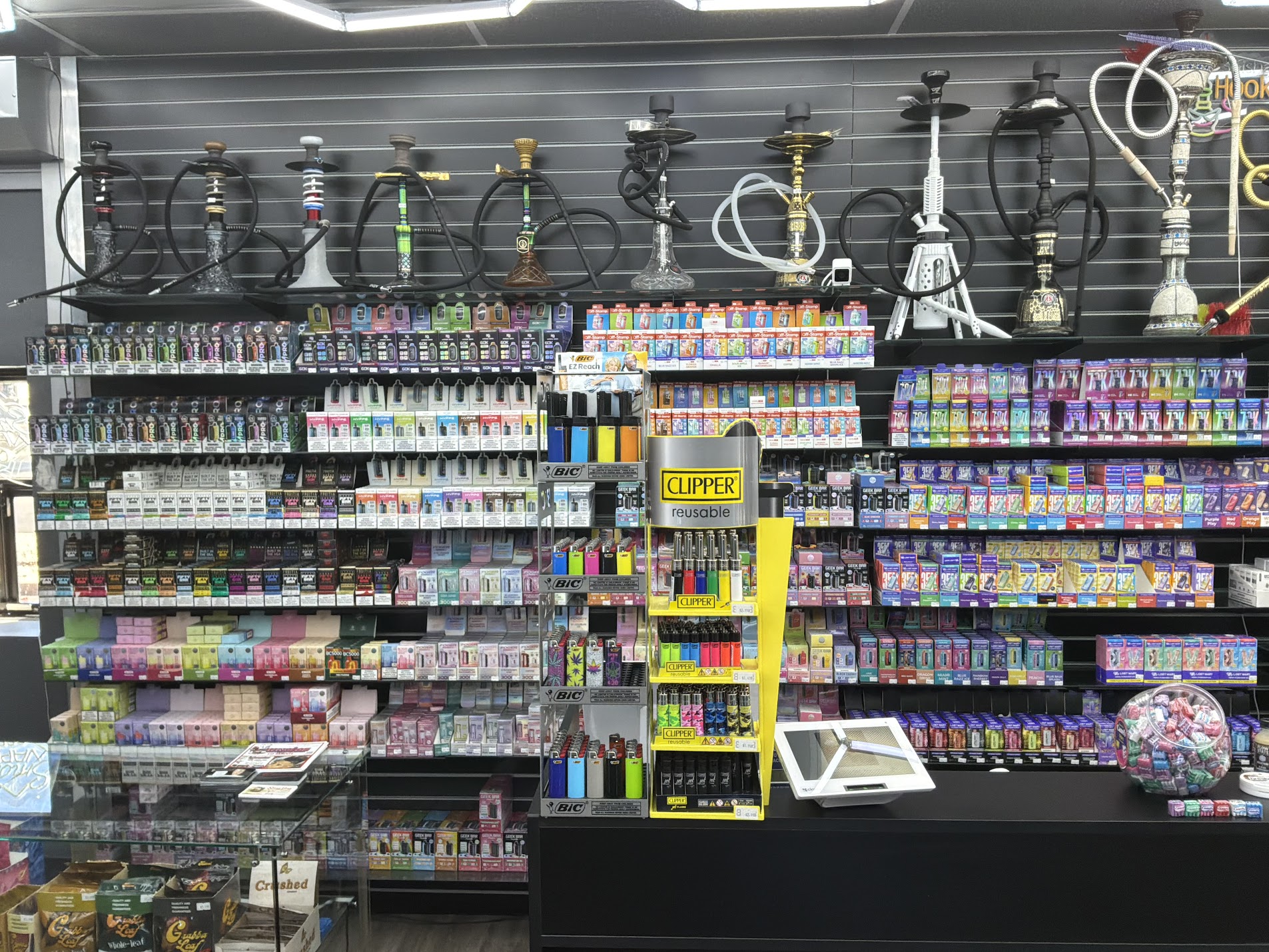 Wall of disposable vapes and hookahs at Smokeland Glendale