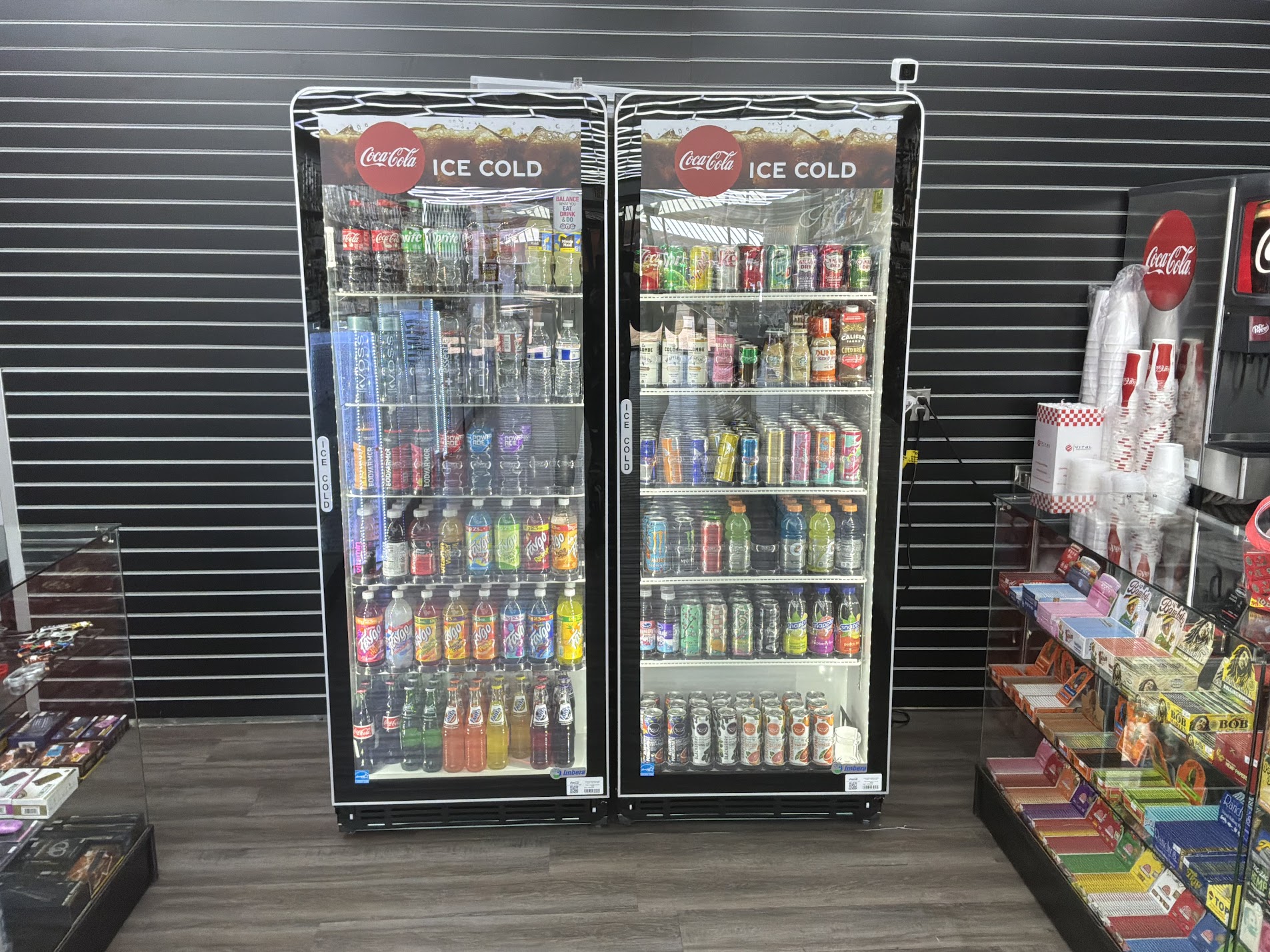 Ice cold Coca-Cola coolers with sodas and drinks